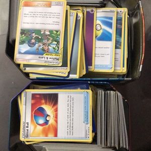 Hundreds of trainer and energy Pokémon cards holo and regular